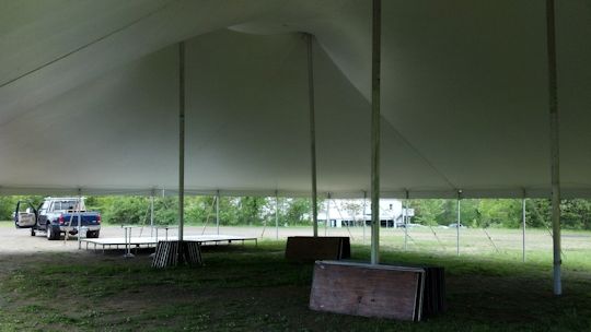 tables stacked neatly under tent for event