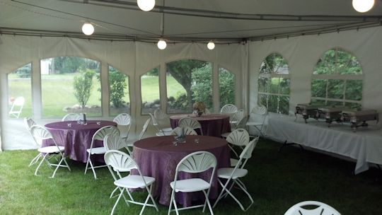 seating with claret table linens under tent