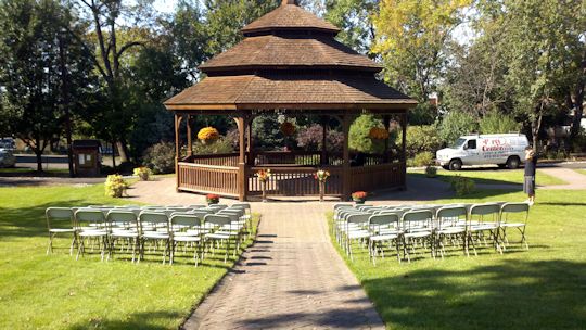 Off white chairs set up in front of gazebo